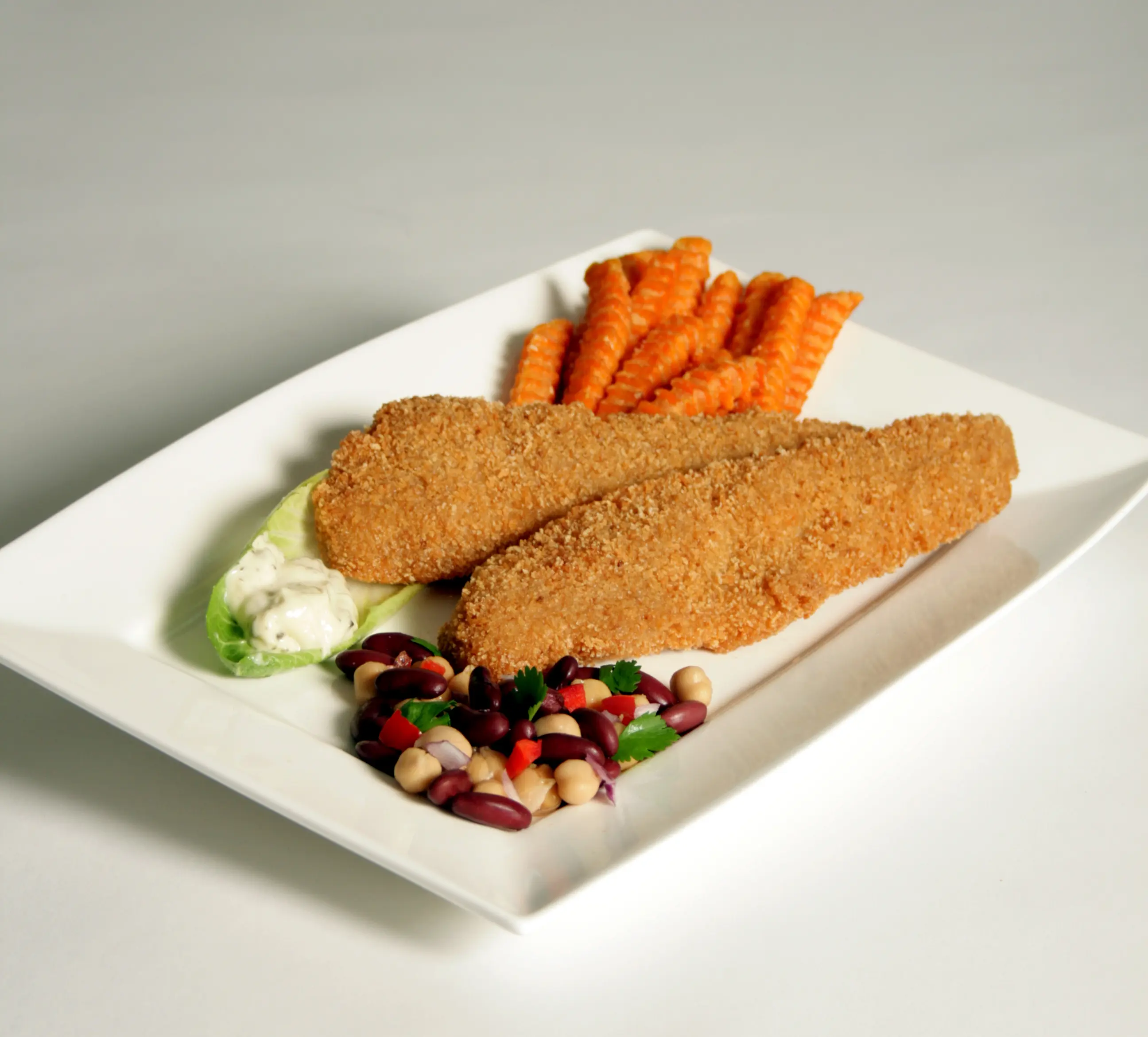 Crumbed Blue Grenadier fillets served with fries and salad